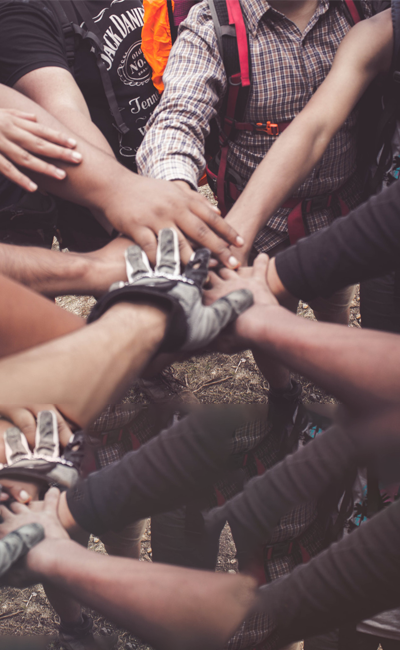 A close up picture of many hands together in a circle